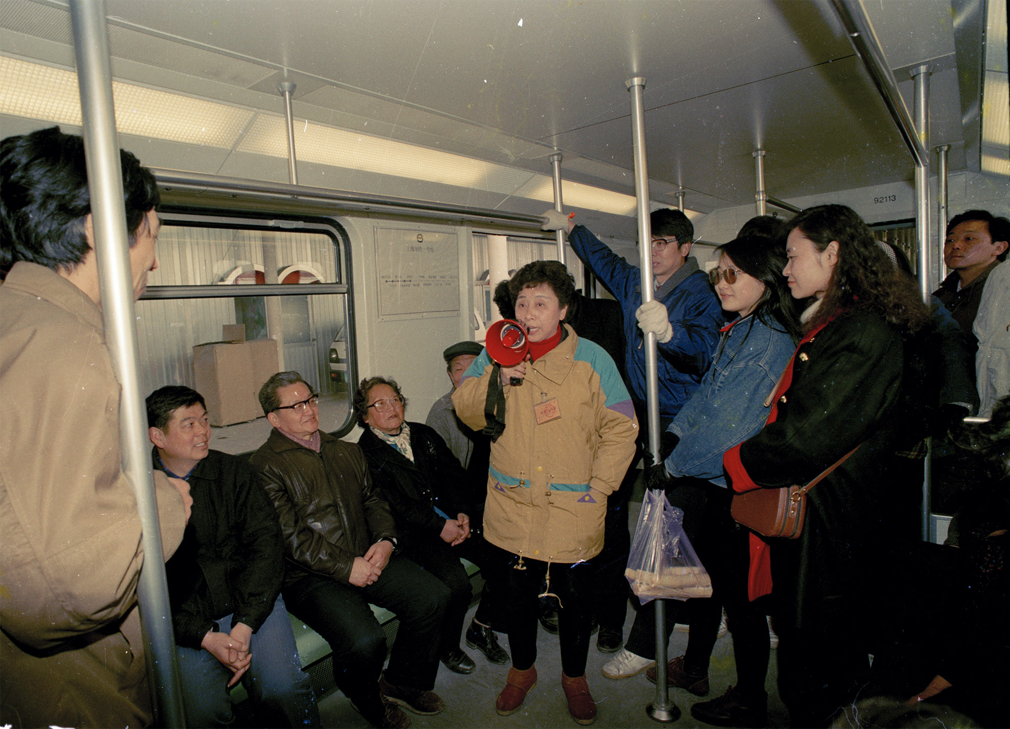 1993年5月28日，上海地铁一号线南段（锦江乐园至徐家汇区间）投入观光试运营。列车上，工作人员正在介绍地铁基本信息。陆杰 图