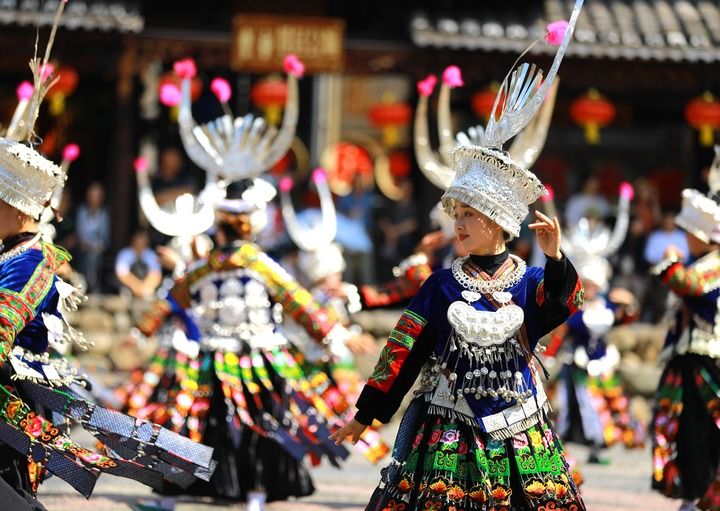 图为9月29日,游客在贵州省黔东南苗族侗族自治州雷山县西江千户苗寨景区观看民族歌舞表演。新华社发(吴贤燕 摄)