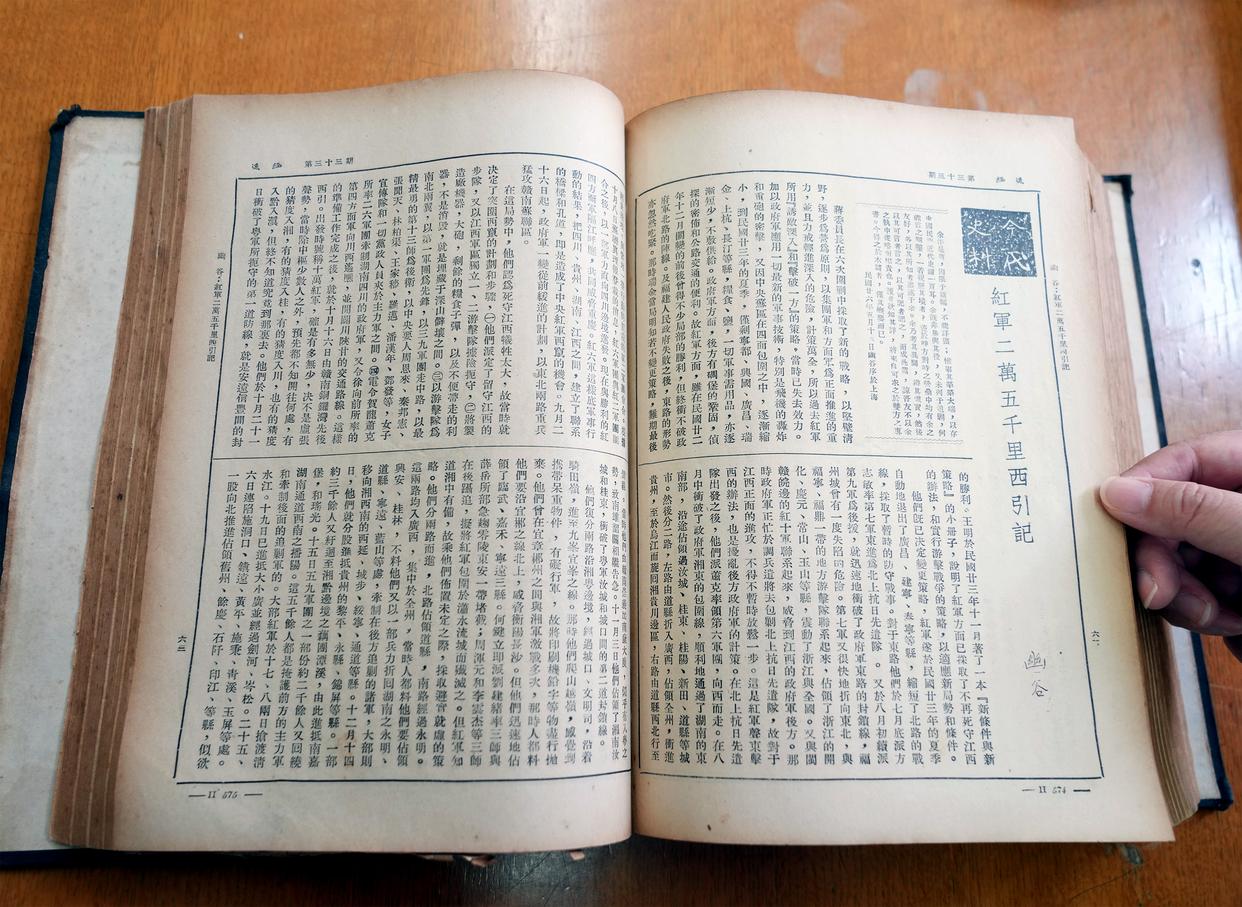 上海图书馆的工作人员翻开《逸经》第33期，展示《红军二万五千里西引记》。<BR/>新华社记者刘颖 摄
