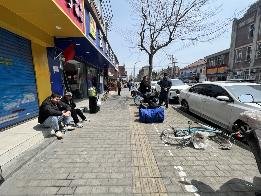 3月27日下午,松江车墩,坐在劳务公司门口的年轻人。