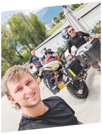 乔(左一)与摩托车旅行者在大理洱海生态廊道旁合影。受访者供图